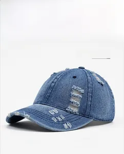 Close-up of distressed denim baseball cap detailing vintage holes and frayed edges