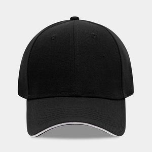 Detail of classic black baseball cap featuring white sandwich brim and cotton twill texture