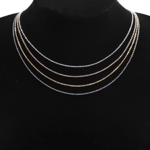 Close-up of 18k gold plated stainless steel cable chains in four diverse metallic colors