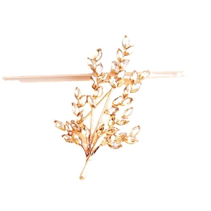 Golden wheat-shaped brooch with amber crystals on a pure white background for women