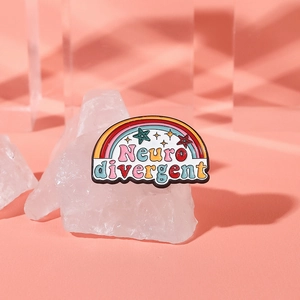 Macro shot of Neurodivergent rainbow enamel pin with stars on white crystal stone