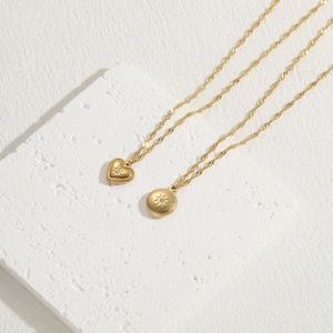 Elegant gold hexagram heart necklace set with sparkling crystals on a textured stone