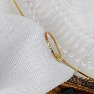 Minimalist 18K gold plated rainbow gemstone ring with colorful zircon stones on white fabric