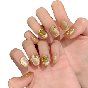 Sparkling orange cat-eye press-on nails with 3D stars and pearl decoration