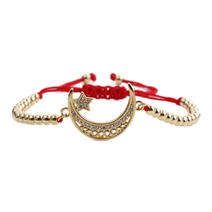 Adjustable gold star and moon bracelet with red woven cord and zircon pendants