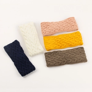 Flat lay of cable knit headbands in navy, cream, pink, yellow, and coffee brown colors