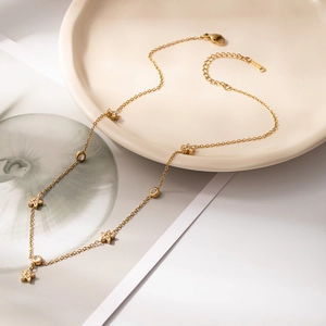 Elegant gold-tone double-layered necklace featuring delicate flower charms and zircon stones