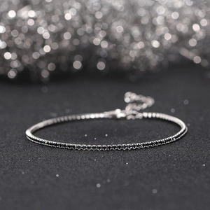 Macro shot of 925 sterling silver tennis bracelet with dense black zircon stones