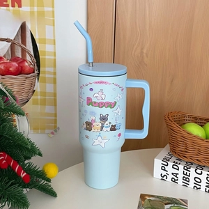 Detail of 40oz light blue insulated tumbler with cartoon puppy design and handle