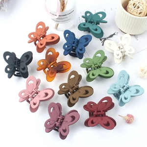 Matte butterfly hair claw clips in various Morandi colors shown on a white background