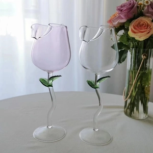 Elegant tulip-shaped wine glasses in clear and lavender glass with green leaf stem design