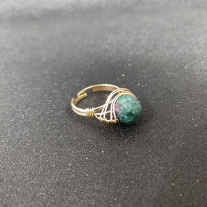 Detailed view of handmade gold wire-wrapped ring with natural Ruby in Zoisite stone