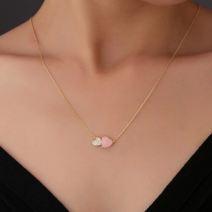 Minimalist gold S925 silver necklace with pink and pavé double heart pendants on a model