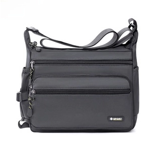 Close-up of waterproof Oxford fabric texture and multi-zipper compartments on crossbody bag