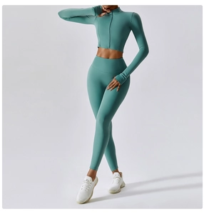 Detail of high-waist teal yoga set with a full-zip long sleeve crop top and leggings