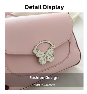 Close-up of elegant pink leather handbag featuring a polished silver butterfly buckle clasp