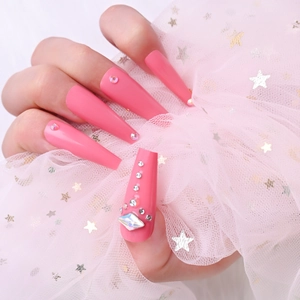 Macro view of long pink coffin press-on nails with sparkling rhinestones and crystals