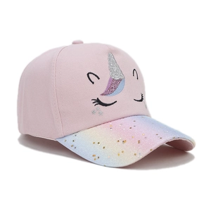 Close-up of kids unicorn baseball cap featuring glitter rainbow brim and embroidery