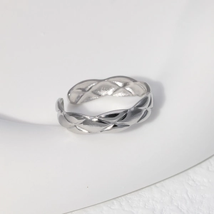 Macro detail of silver adjustable ring with textured quilted diamond pattern finish