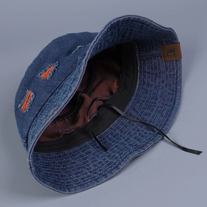 Detail view of denim bucket hat showing inner lining and adjustable drawstring