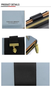 Detail view of blue and black PU leather wallet with golden leaf pendant and zip