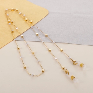 Close-up of gold glasses chain with square beads, pearls and lobster clasp closures