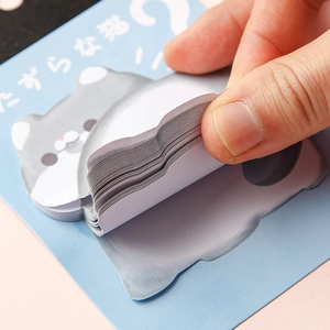 Cute gray cat shaped sticky notes with layered paper sheets on a blue background card