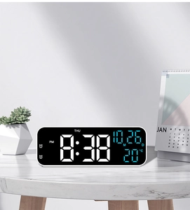 Detail view of 9-inch LED clock on marble surface showing time, date, and 20°C temperature