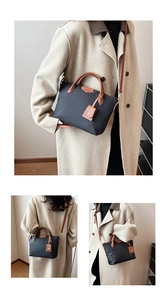 Detailed views of black nylon tote bag with leather trim worn as a crossbody bag