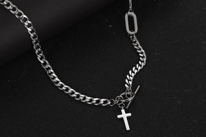 Detail of silver titanium cross necklace with chunky Cuban chain and OT toggle clasp
