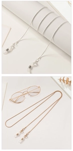 Detail of elegant gold and silver snake chain eyeglass straps with silicone loops