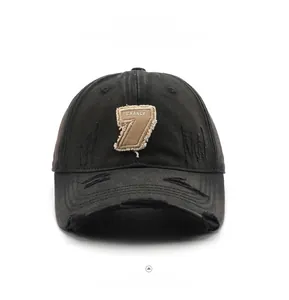 Detail of distressed dark gray washed canvas baseball cap with embroidered 7 and CHANGE patch