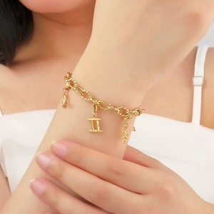 14K gold plated stainless steel bracelet featuring a Gemini zodiac charm on a link chain