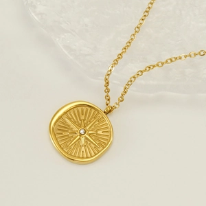 Minimalist gold stainless steel starburst compass necklace with sparkling zircon pendant