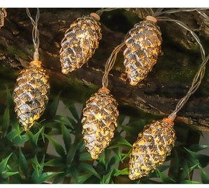 Close-up of pinecone LED string lights with warm glow on rustic tree bark and green leaves