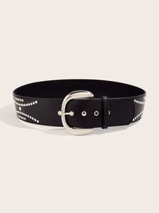 Detail of black leather belt featuring silver horseshoe buckle and stud embellishments