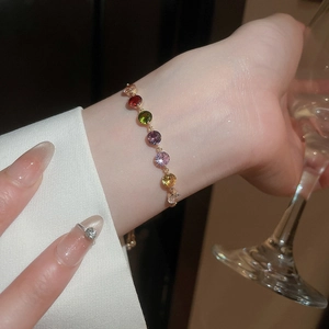 Close-up of vibrant multicolored zircon teardrop bracelet with an elegant gold finish