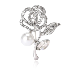 Silver rose brooch with sparkling crystals and a white pearl center on white background
