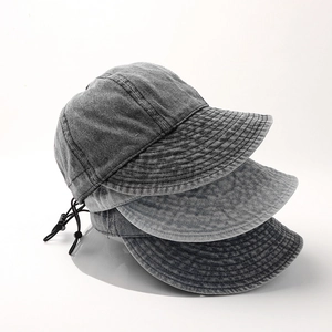 Detail of washed denim baseball caps with reinforced stitching and adjustable drawstring
