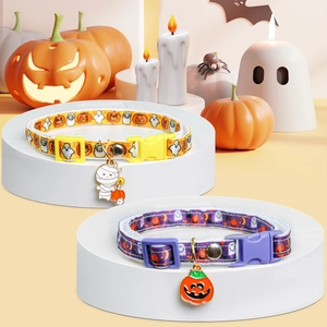 Detail of Halloween pet collars with pumpkin and ghost patterns on a festive display