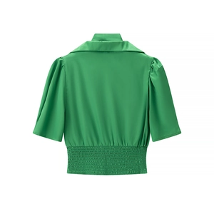 Back view of a green satin short sleeve blouse with puffed sleeves and elastic smocked waist