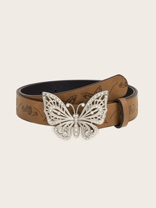 Macro detail of brown leather belt featuring floral embossing and a silver butterfly buckle