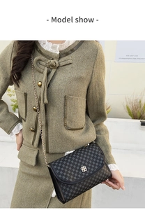Detail of vintage square crossbody bag with clover pattern and flower metal clasp