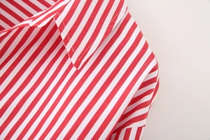 Detail of red and white striped poplin shirt neckline and stitching on shoulder