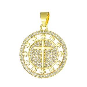 Detailed macro of a gold circular pendant featuring a zircon cross inlay and pave gems