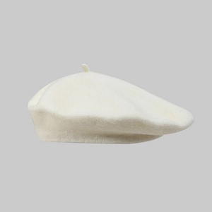 Detail view of cream-white wool beret hat showing soft texture and premium fabric weave