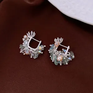 Elegant silver earrings with pink pearls, blue gemstones and crystals on brown silk