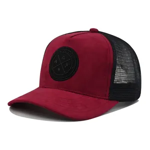 Detail of red faux suede trucker hat with black breathable mesh and round patch label