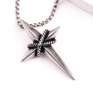 Close-up of vintage stainless steel star pendant with textured details on box chain