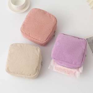 Macro view of corduroy sanitary napkin pouches in various colors for daily storage